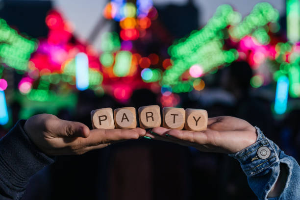 Two hands holding cubes forming the word party