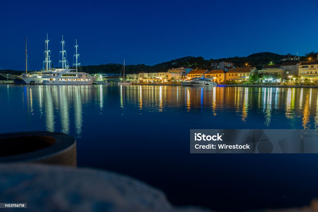 Sali harbor in croatia, take at night, Dugi Otok island, Croatia The beautiful Sali Harbor at night with a big boat. Colour of the town and light reflection on the sea Beauty Stock Photo