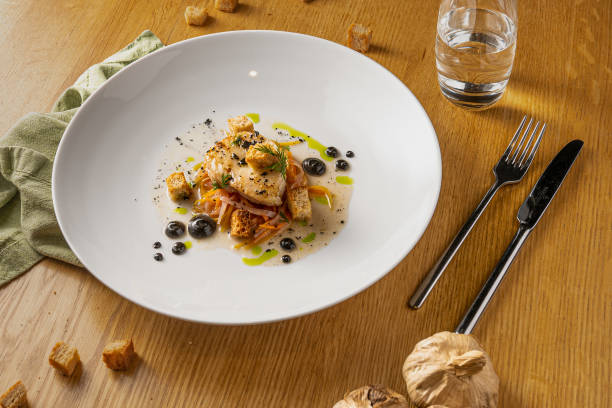 istock Delicious dish with fish, vegetables, and special sauce 1453756828