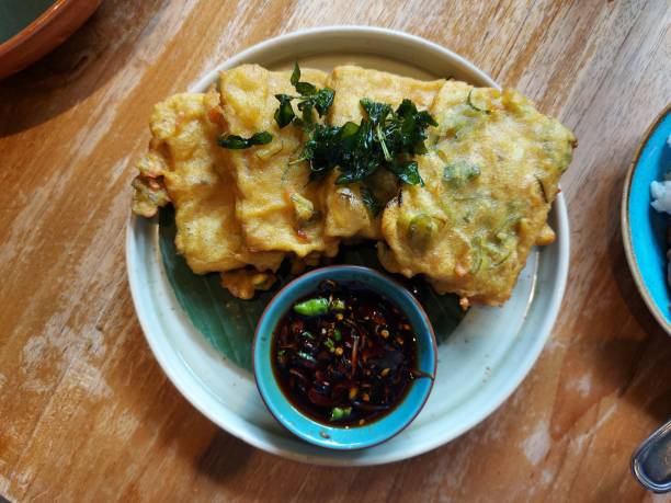 Tempe mendoan. It is traditional snack from indonesia Tempe mendoan. It is traditional snack from indonesia. Made from tempeh wrapped with flour. Usually served with sweet soy sauce and chili. Savory taste. gorengan stock pictures, royalty-free photos & images