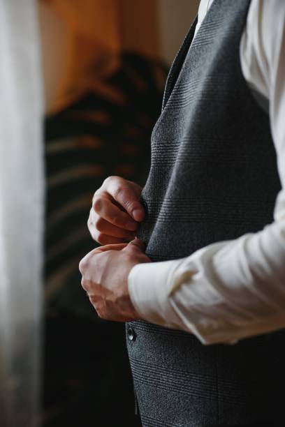 istock A man fastens buttons on his shirt 1453758153