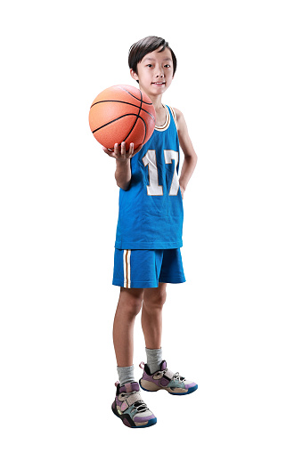 asian boy holding a basketball against white background