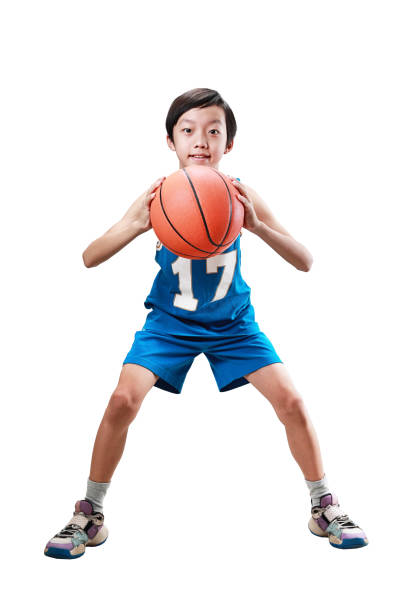 istock Young boy playing basketball isolated on white 1453759266