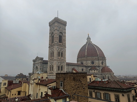 Florence cathedral dome and city rooftops in cloudy weather