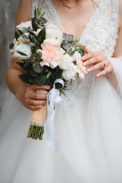 istock Bride holds a wedding bouquet, wedding dress, wedding details. 1453761277