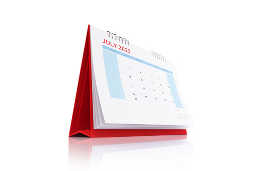 2023 Red July Desk Calendar Standing on White Reflective Background