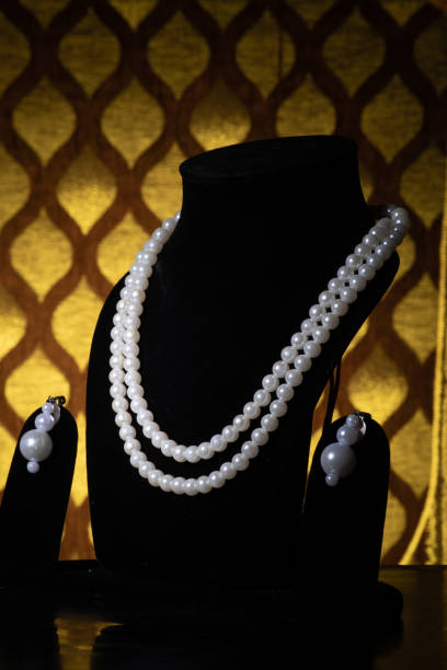 istock White pearl necklace with earrings on mannequin 1453762416