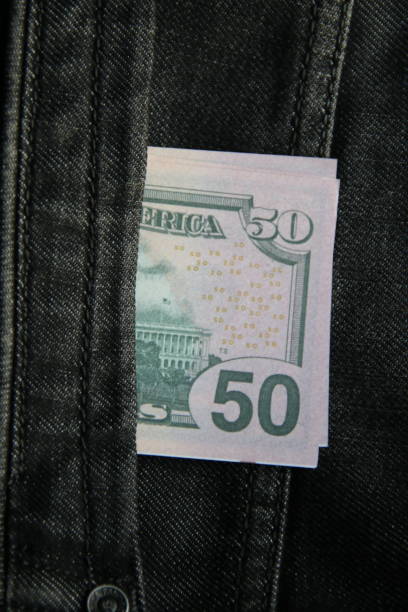 istock American dollars USD banknotes in jeans pocket. 1453763561