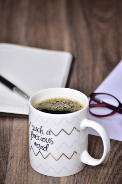 istock Black coffee in motivational quote mug at table 1453764243