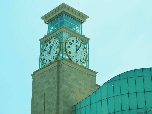 istock Cream gray clock tower and silver blue sky roof 1453765145