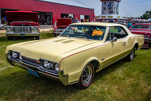 Iola, WI - July 07, 2022: High perspective front corner view of a 1967 Oldsmobile 442 Cutlass Supreme Holiday Coupe at a local car show.