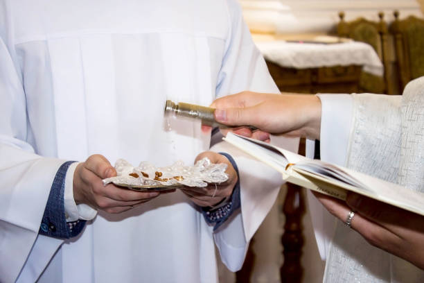 istock Sprinkling wedding rings with holy water at the wedding ceremony 1453765481