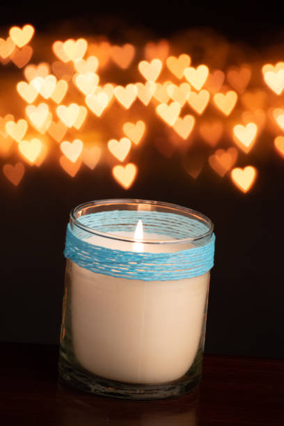 istock Jar candle burning on yellow bokeh effect 1453766785