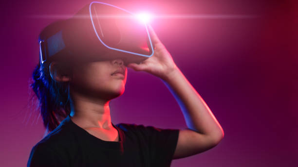 istock happy girl in glasses of virtual reality. Augmented reality, science, future technology concept. VR. Futuristic 3d glasses with virtual projection. Neon light. 1453767729
