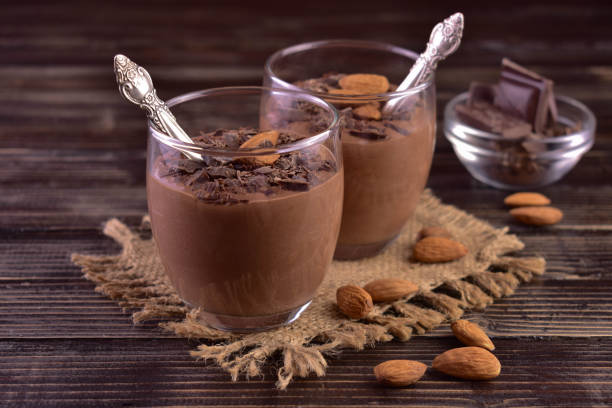 istock Chocolate mousse with almonds in glasses on a dark wooden background. 1453768249