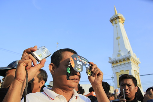 Yogyakarta, Indonesia, March 9, 2016. Residents witness the phenomenon of a total solar eclipse with the help of simple tools.