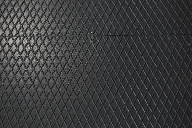 istock Black metal texture steel background. Perforated sheet metal. 1453769499