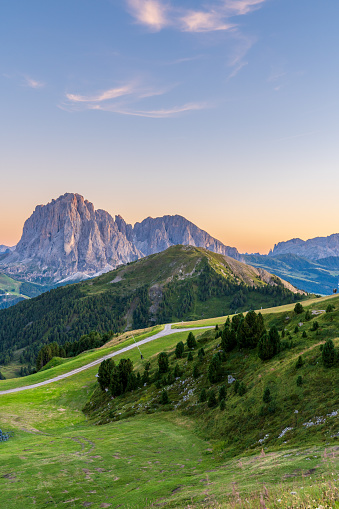 Aerial view of Italian alps Dolomites, surrounded by green meadows - Puez Geisler Nature Park.