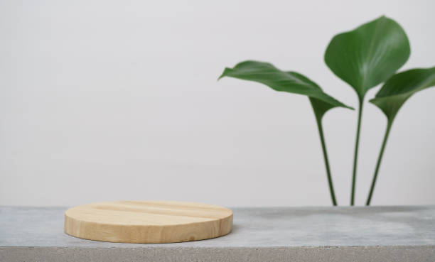 istock empty wooden podium texture on cement tabletop with fresh green leaf white space background.organic healthy natural product pedestal platform promotion show display,spring banner concept design. 1453772149