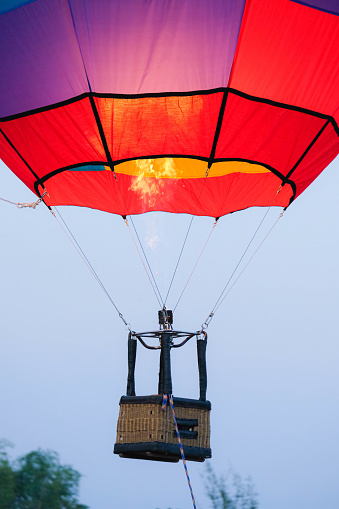 Gas burner blowing up hot air balloon. Slow motion scene of flames rising and inflating hot air balloons. Preparing for a balloon flight