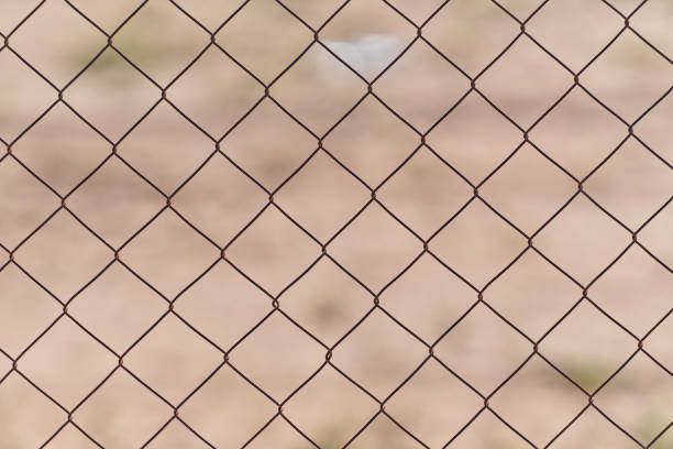 Metal fence with brown background