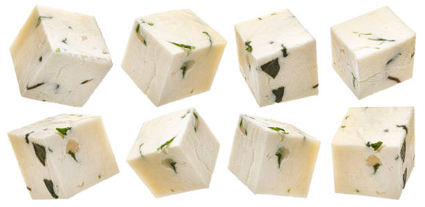 Sliced feta cubes, diced curd cheese pieces isolated on white background Sliced feta cubes, diced curd cheese pieces with herbs and spices isolated on white background, collection feta cheese block stock pictures, royalty-free photos & images