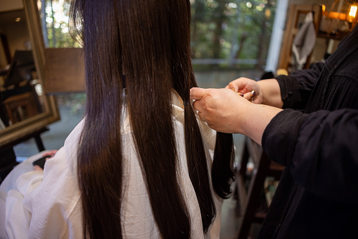 Japanese woman cutting hair for hair donation