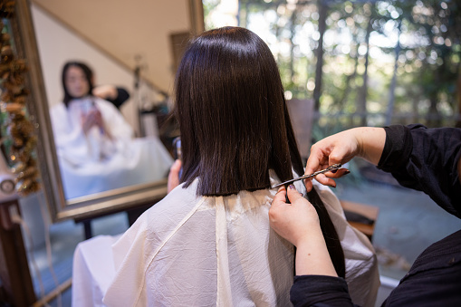 Japanese woman cutting hair for hair donation