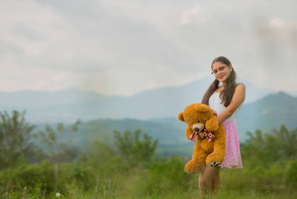 Young woman outdoors in her favorite hobbies, reading, enjoying and playing guitar.