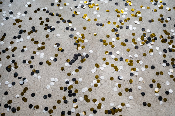 istock gold, black white confetti on concrete. Background 1453790341