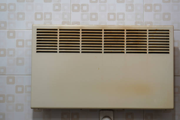 white electric heating radiator mounted on the wall