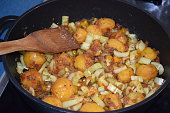 frying pan with potatoes, meat and a lot of paprika