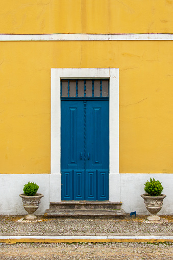 Blue door in yellow building.