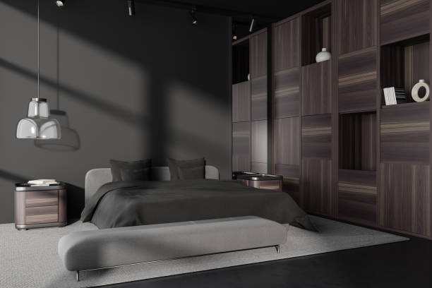 istock Corner view on dark bedroom interior with bed, bedsides, cupboard 1453791911