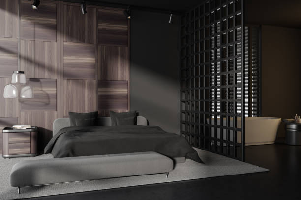istock Dark bedroom interior with bed and bathing corner with tub and accessories 1453794900
