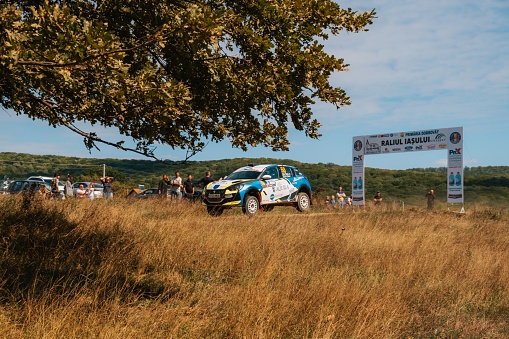 Iasi, Romania – September 25, 2022: a shot of people and cars at Iasi Rally 2022, during a beautiful autumn