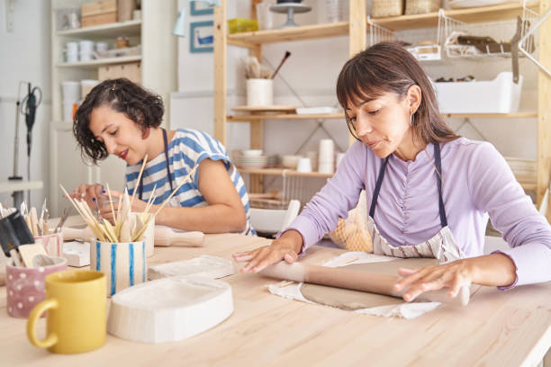 istock Two women working with clay in a pottery workshop. 1453796498