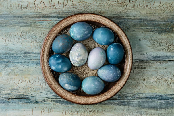 istock Aquamarine easter eggs in ceramic bowl on wooden background 1453796741