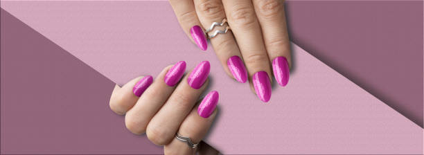 istock Beautiful woman's hands with springtime pink with glitter nail art 1453796785