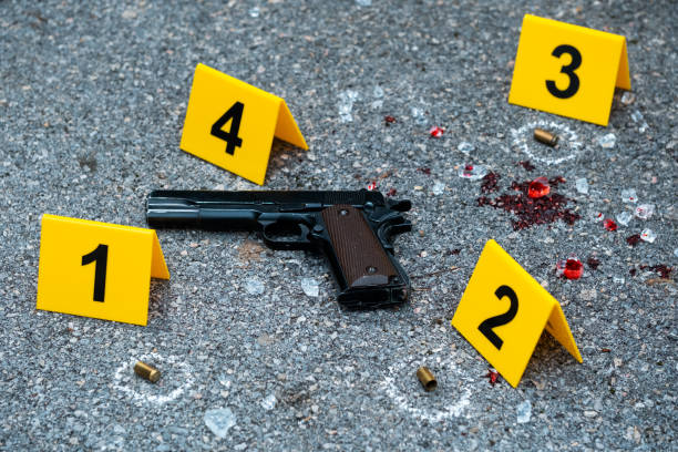 Crime scene Bullet casings and gun on the floor. Crime scene. evidence stock pictures, royalty-free photos & images