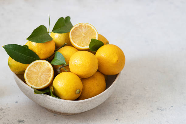istock Fresh lemons in a bowl on the table 1453799426