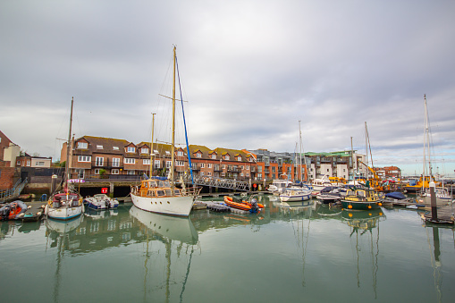 Ramsgate, England - March 3 2020 Yachts moored in the marina of the impressive historic Royal Harbour on a cool but bright winter day.