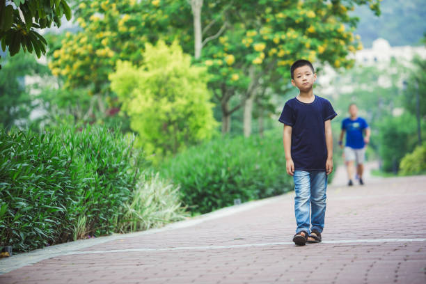 A little boy was walking in the park