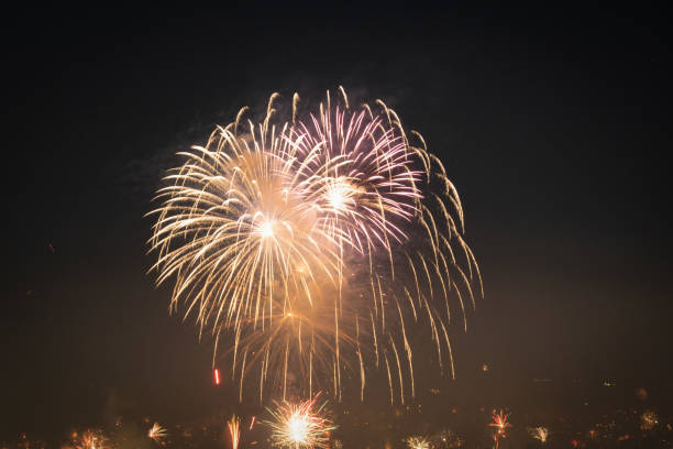 istock Series of real fireworks against black sky at night. Pyrotechnics exploding, celebrating the coming of the New Year. 1453802374