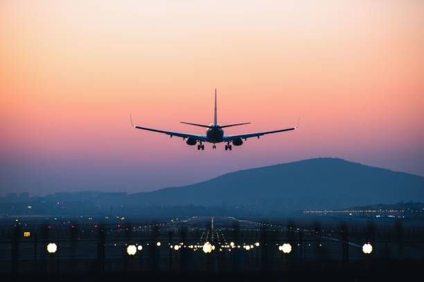 istock Airplane departing from airport during sunset 1453802683
