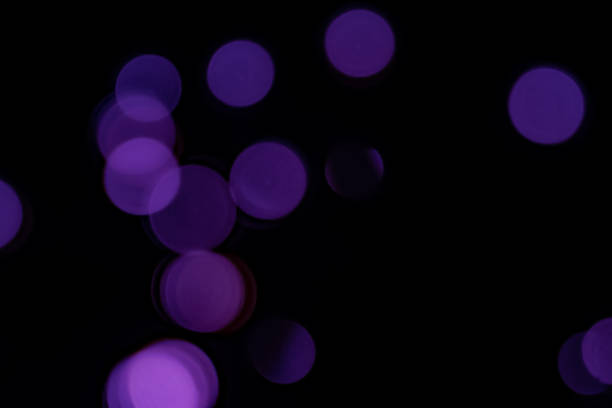Purple blurry bokeh lights on black background
