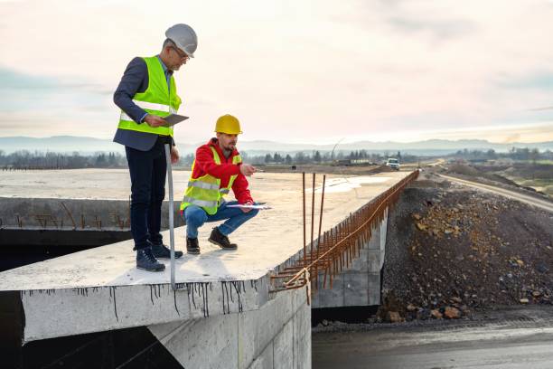istock Engineer and investor on a road construction site 1453804818