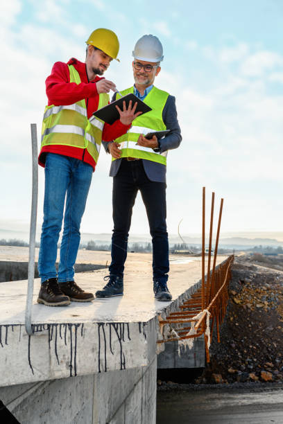 istock Engineer and investor on a road construction site 1453806640