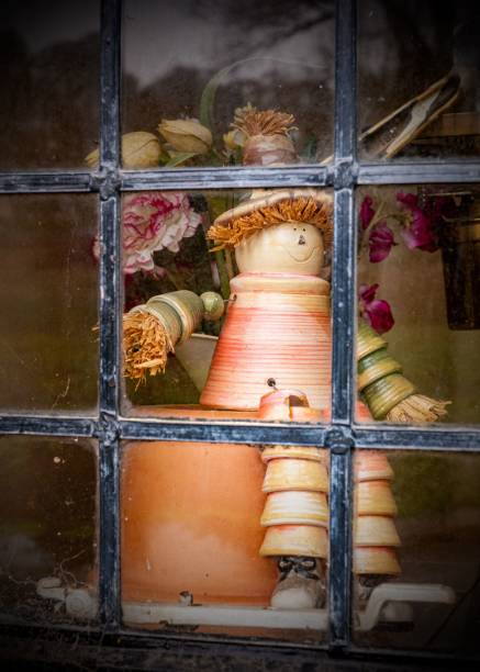 istock Cute flowerpot man behind a window metal grid 1453808312