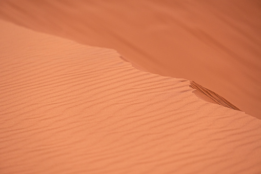 Dune ridge and wind pattern in the sand of the Sahara desert.